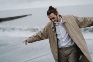 Man in Brown Coat Smoking Cigarette