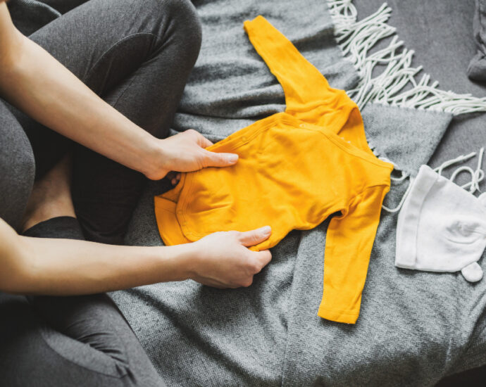 young-woman-preparing-clothes-baby