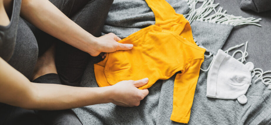 young-woman-preparing-clothes-baby